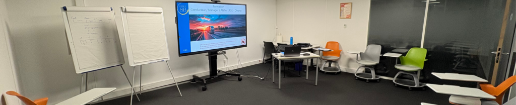 Salle de formation chronotachygraphe en entreprise, avec écran et paperboard